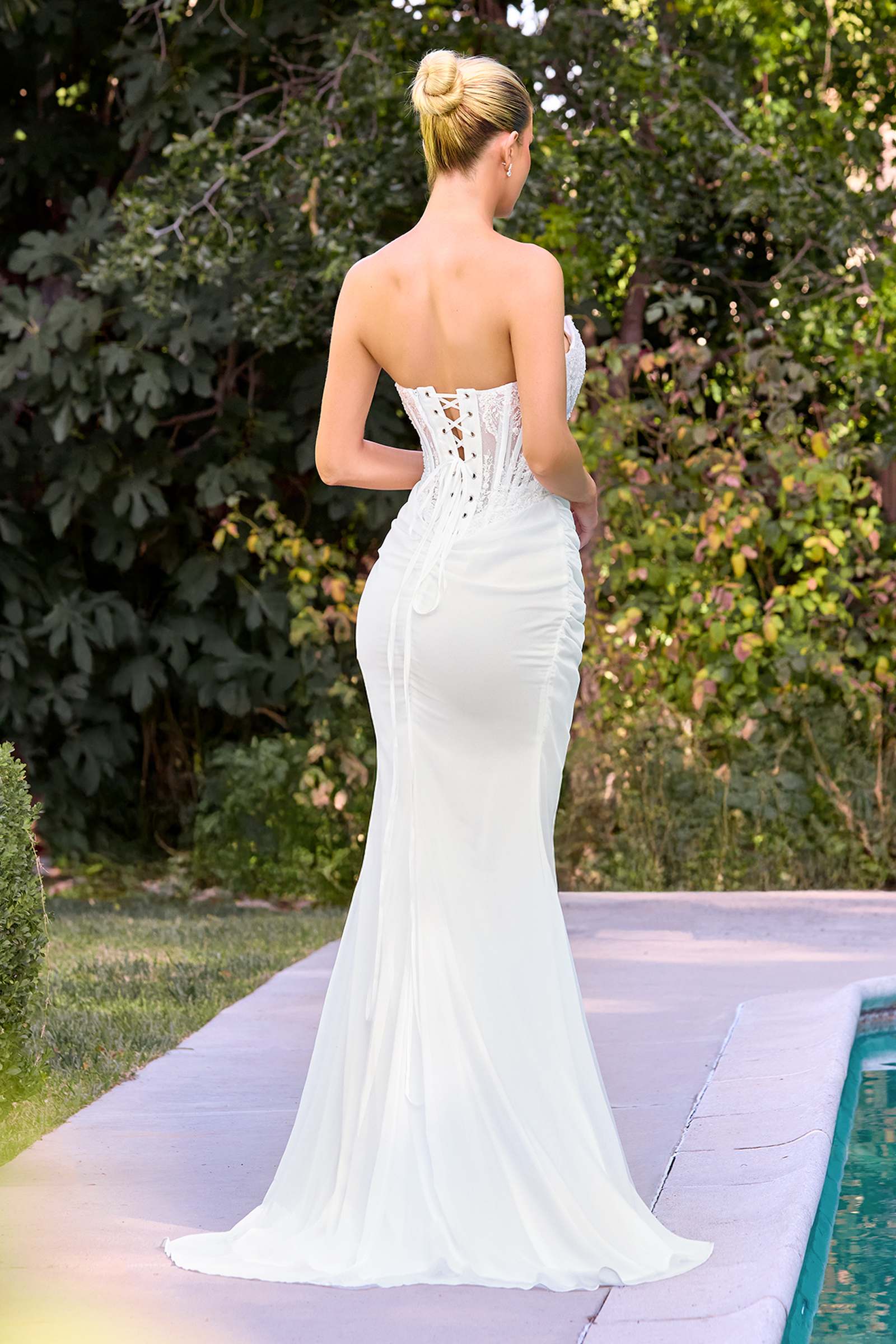 Off-white strapless fitted bridal gown, lace back with exposed corset detail