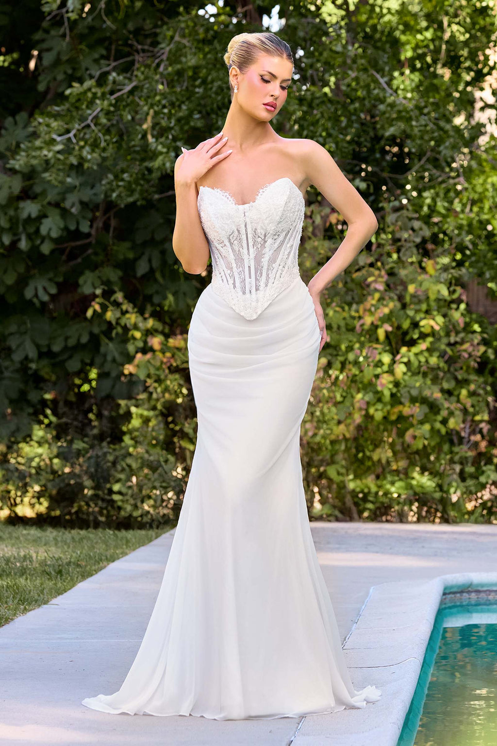 Off-white strapless fitted bridal gown with lace corset bodice and sweetheart neckline