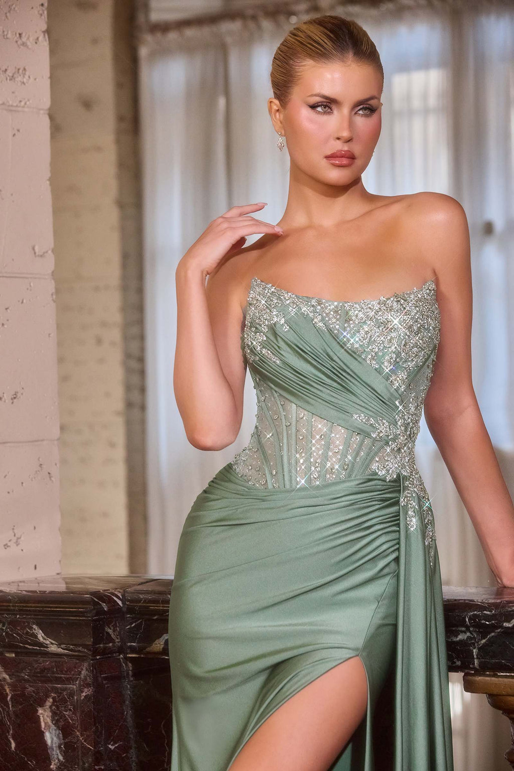Sage green strapless satin gown with jeweled bodice and side draped thigh slit
