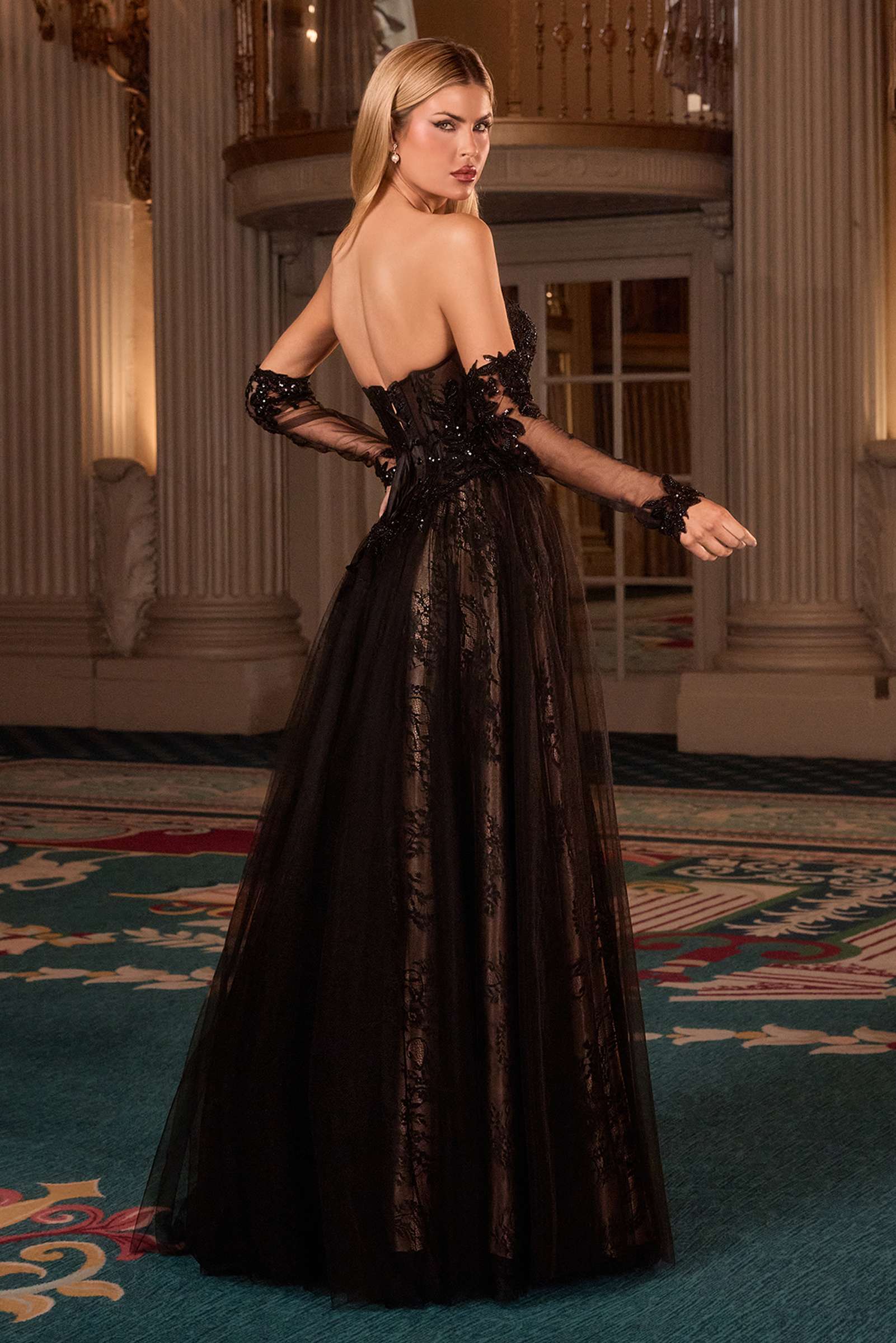 Black strapless gown with lace sleeves and open back, full A-line tulle skirt