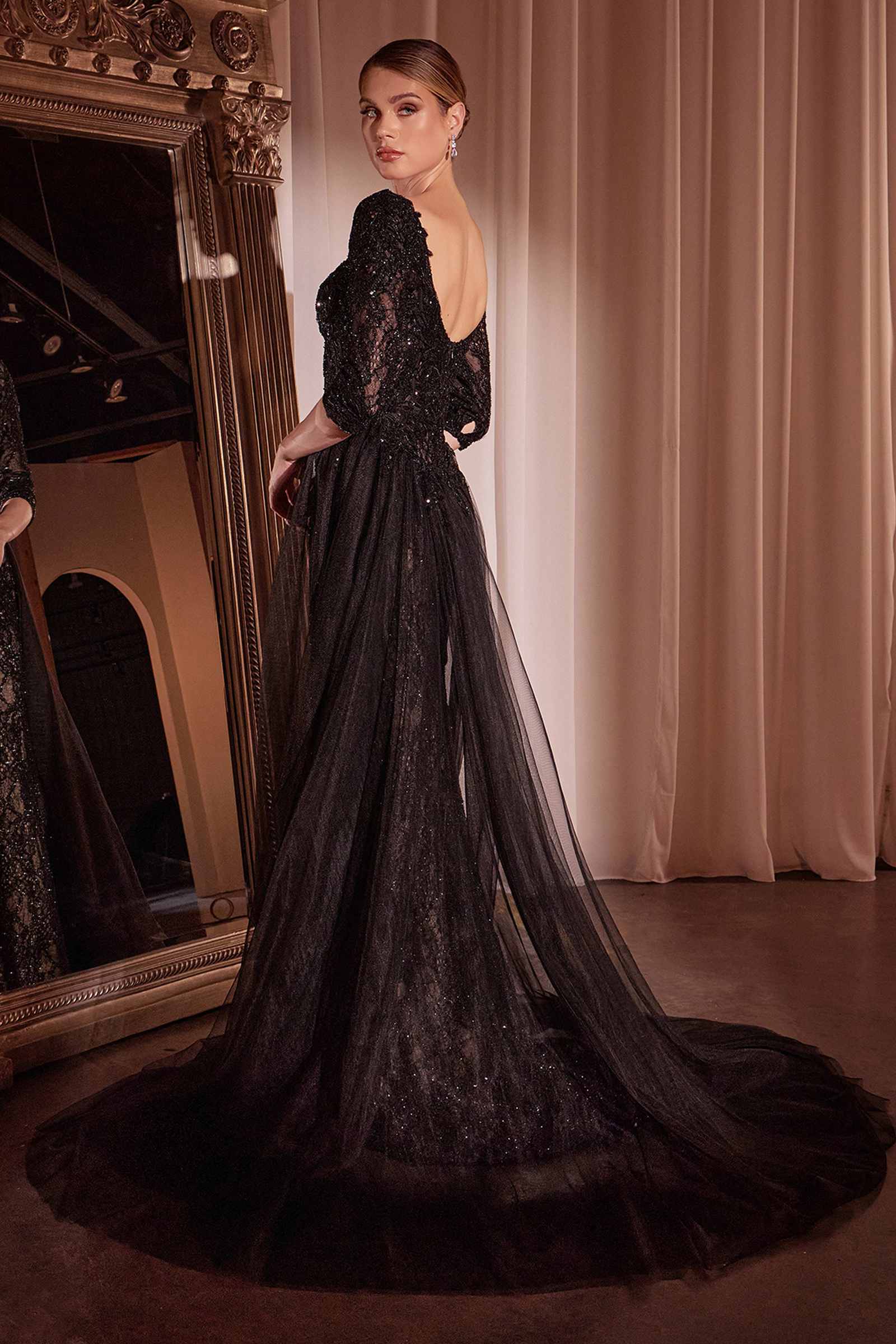 Black lace mermaid gown with one long sleeve, fitted bodice, and dramatic train