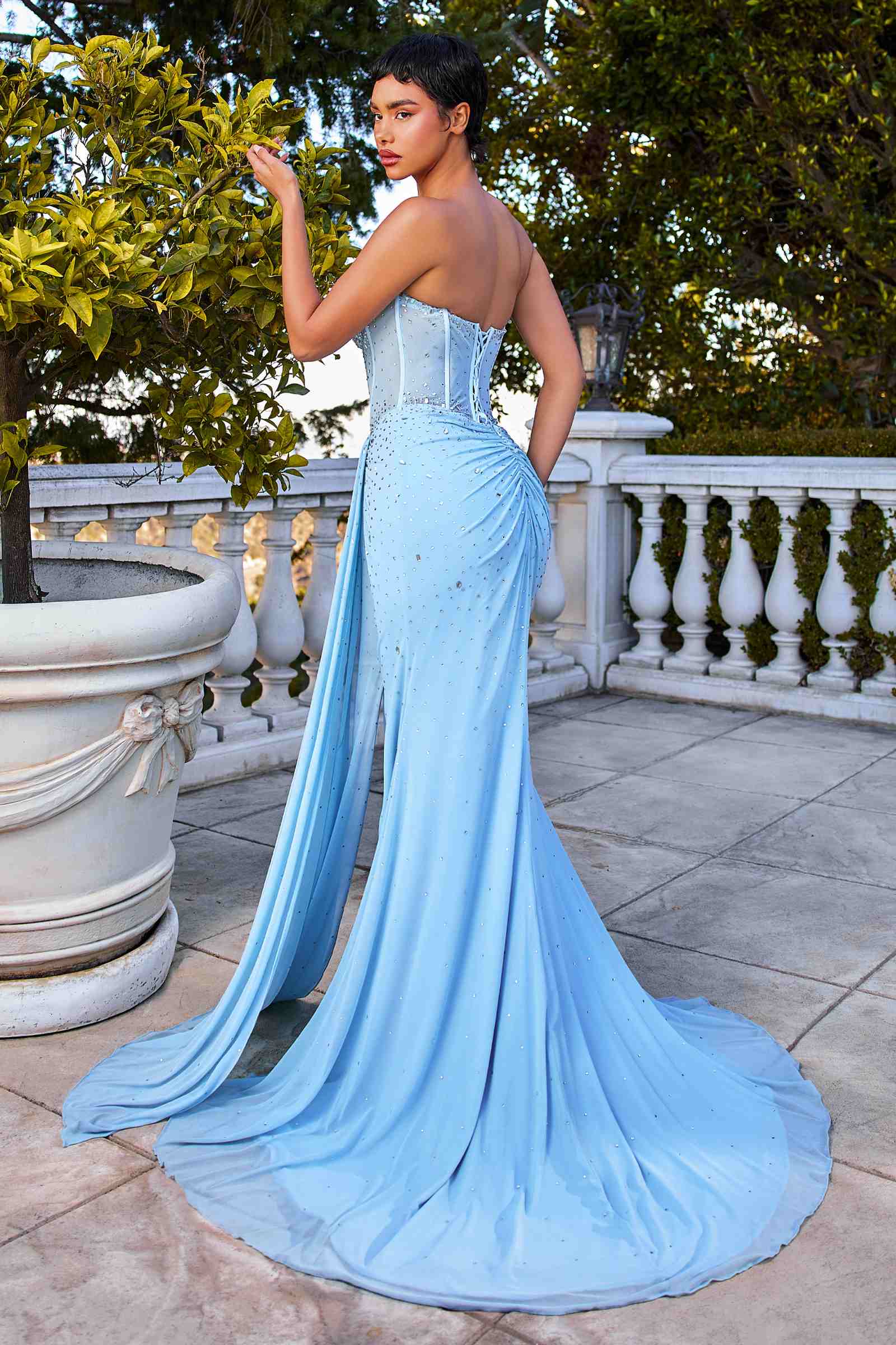Light blue strapless fitted stretch net dress with scattered rhinestones and draped waist