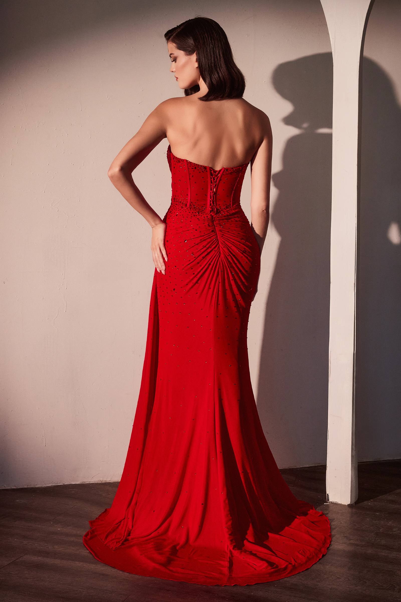 Red fitted strapless stretch net dress with open back and scattered rhinestone details