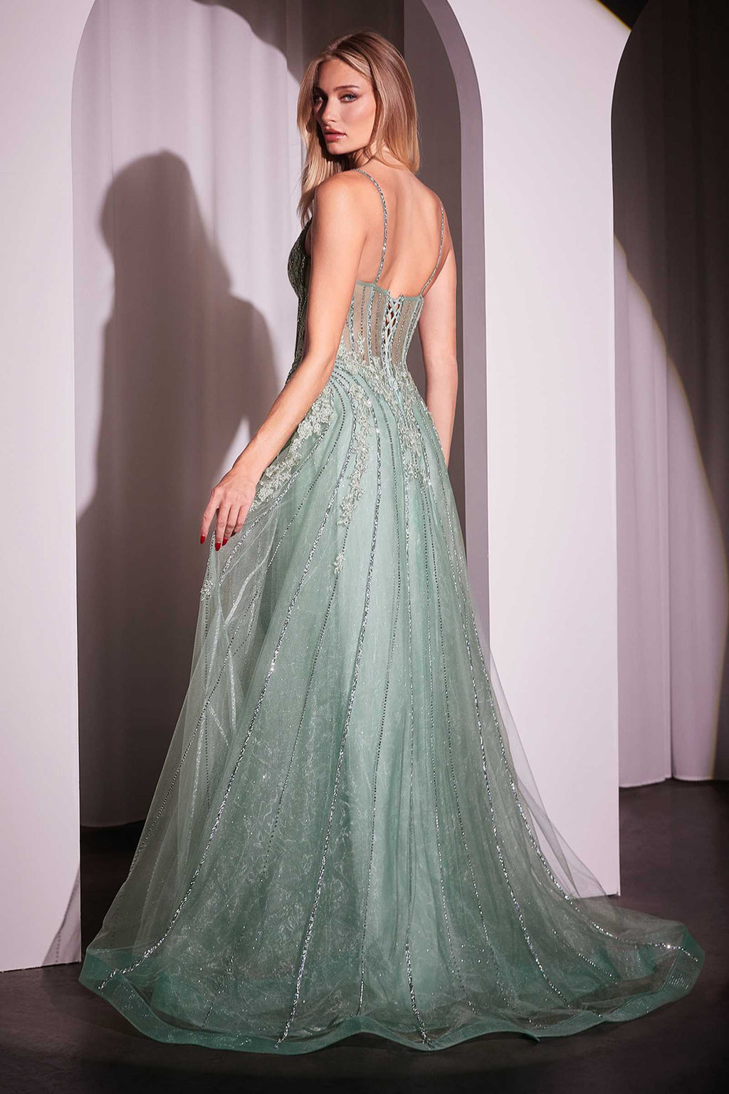 Sage green crystal-embellished A-line tulle gown with sheer flared skirt and spaghetti straps