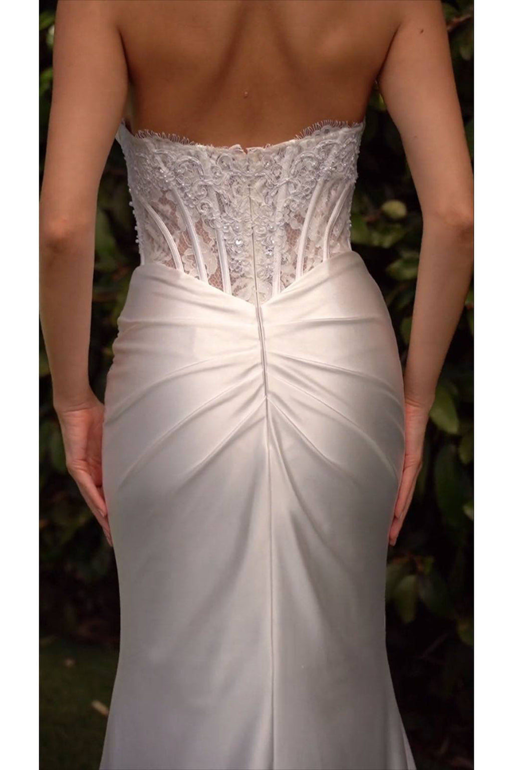 Off-white strapless satin wedding dress with lace corset top and draped center seam