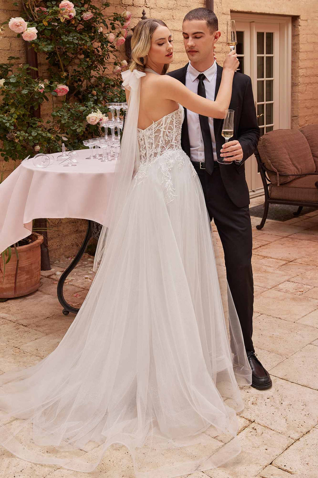 Off-white tulle wedding ball gown with lace corset bodice, convertible straps, and train