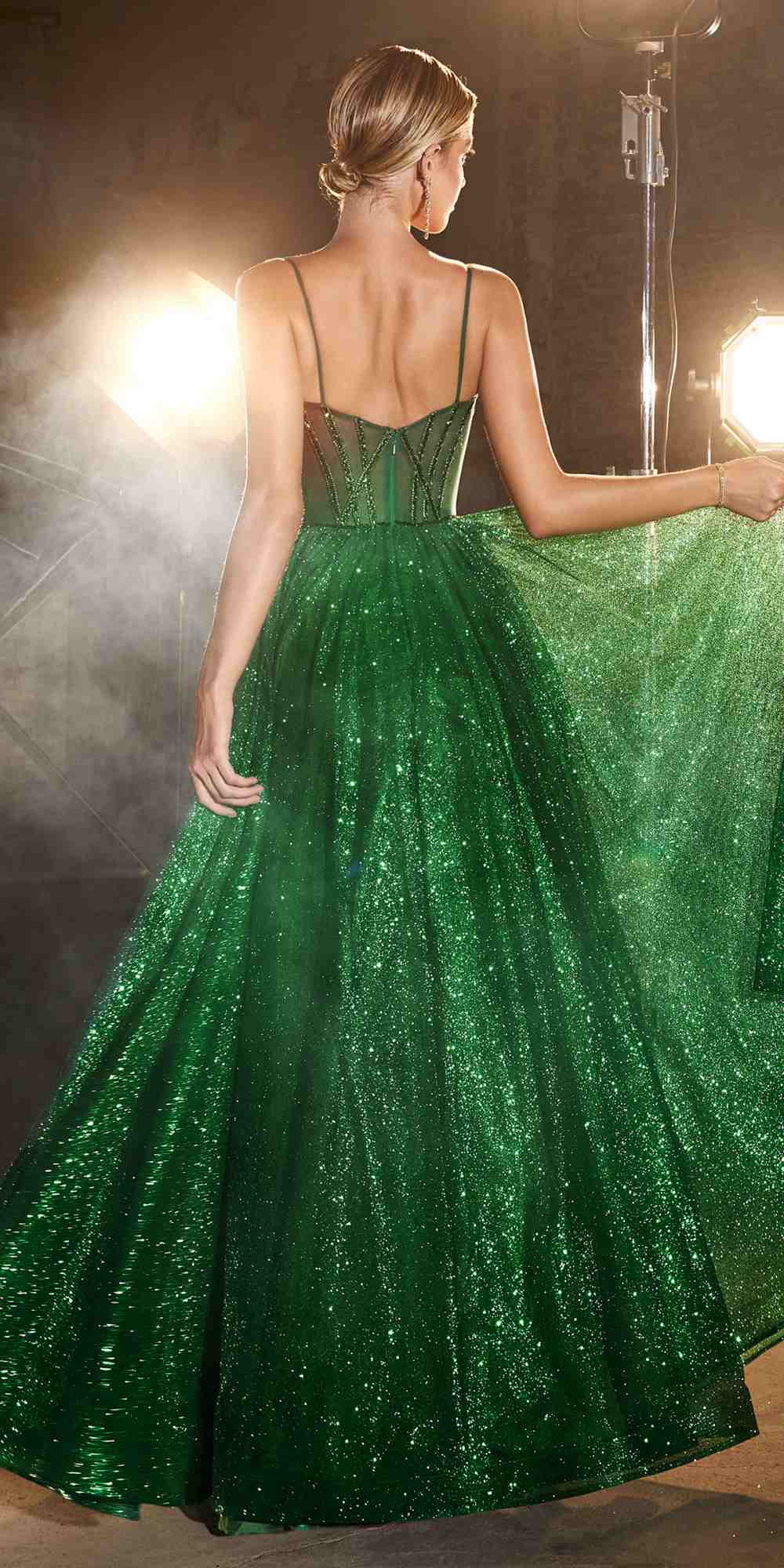 Green glitter ball gown with corset-style bodice, open back and full pleated skirt