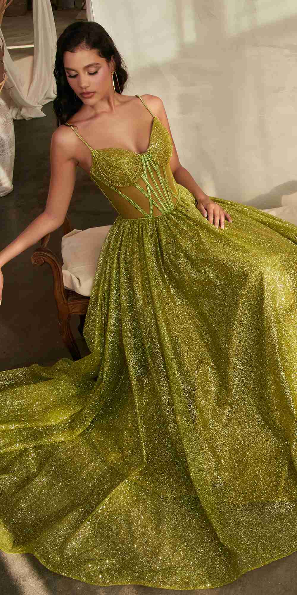 Gold glitter ball gown with corset-style spaghetti straps and full flared skirt