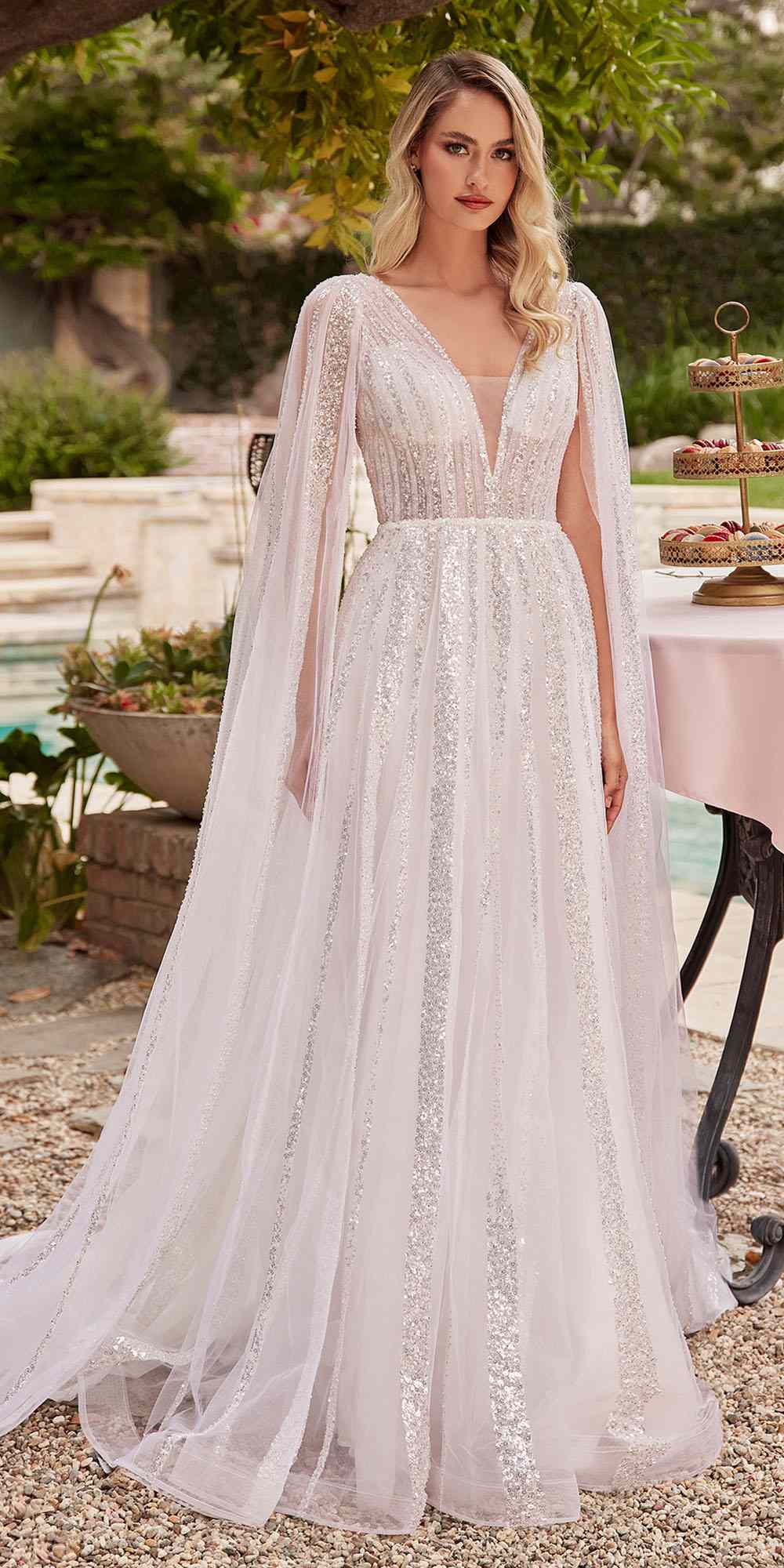 Off-white A-line wedding gown in layered tulle, long sleeves, V-neck, draped skirt