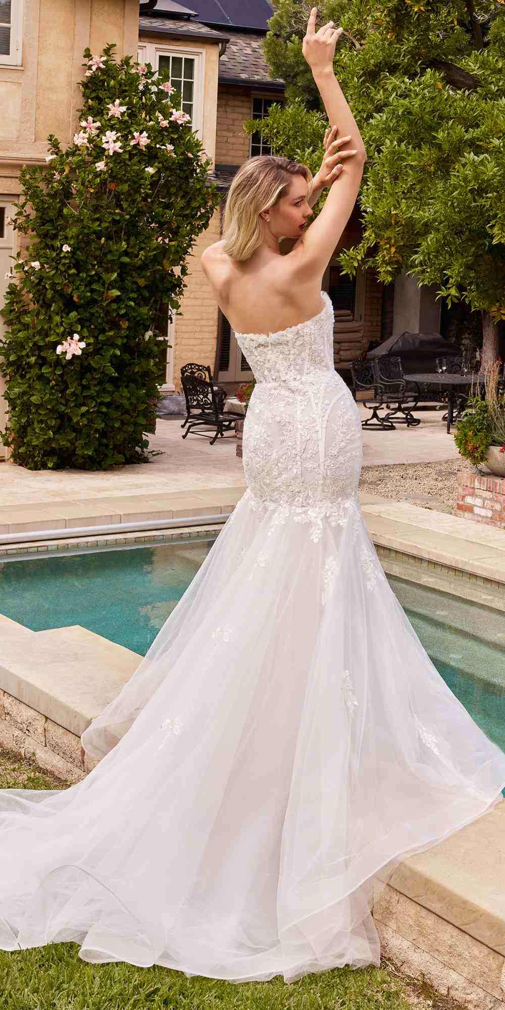 Off-white strapless mermaid dress with lace bodice and flared tulle hem, back view
