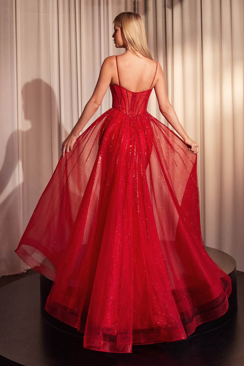 Red backless fitted beaded tulle gown with thin straps and full flared skirt