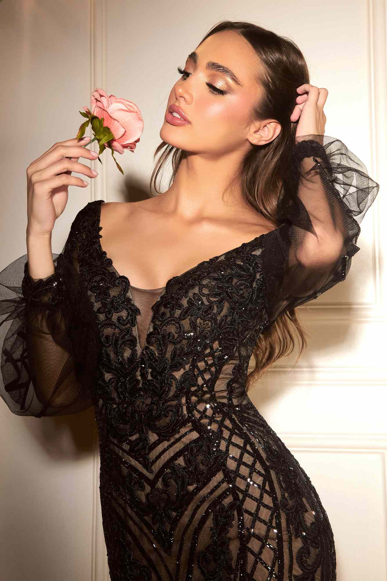 Black embellished V-neck gown with long sheer bishop sleeves and ornate lace beadwork.