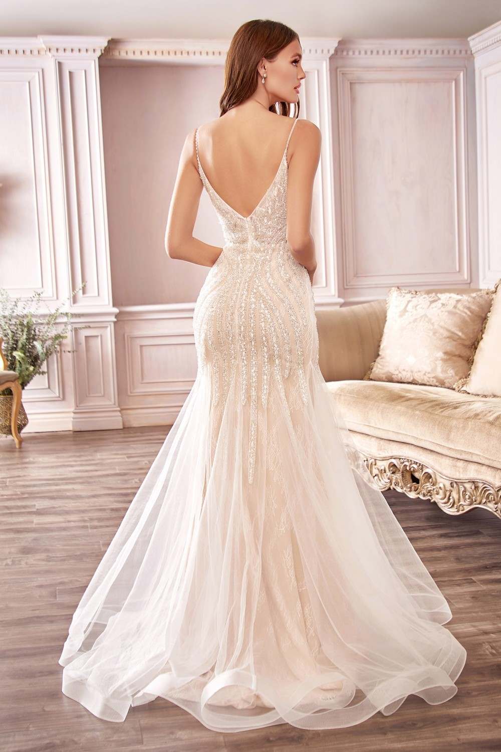 Off-white beaded mermaid wedding dress with open back and flowing tulle train