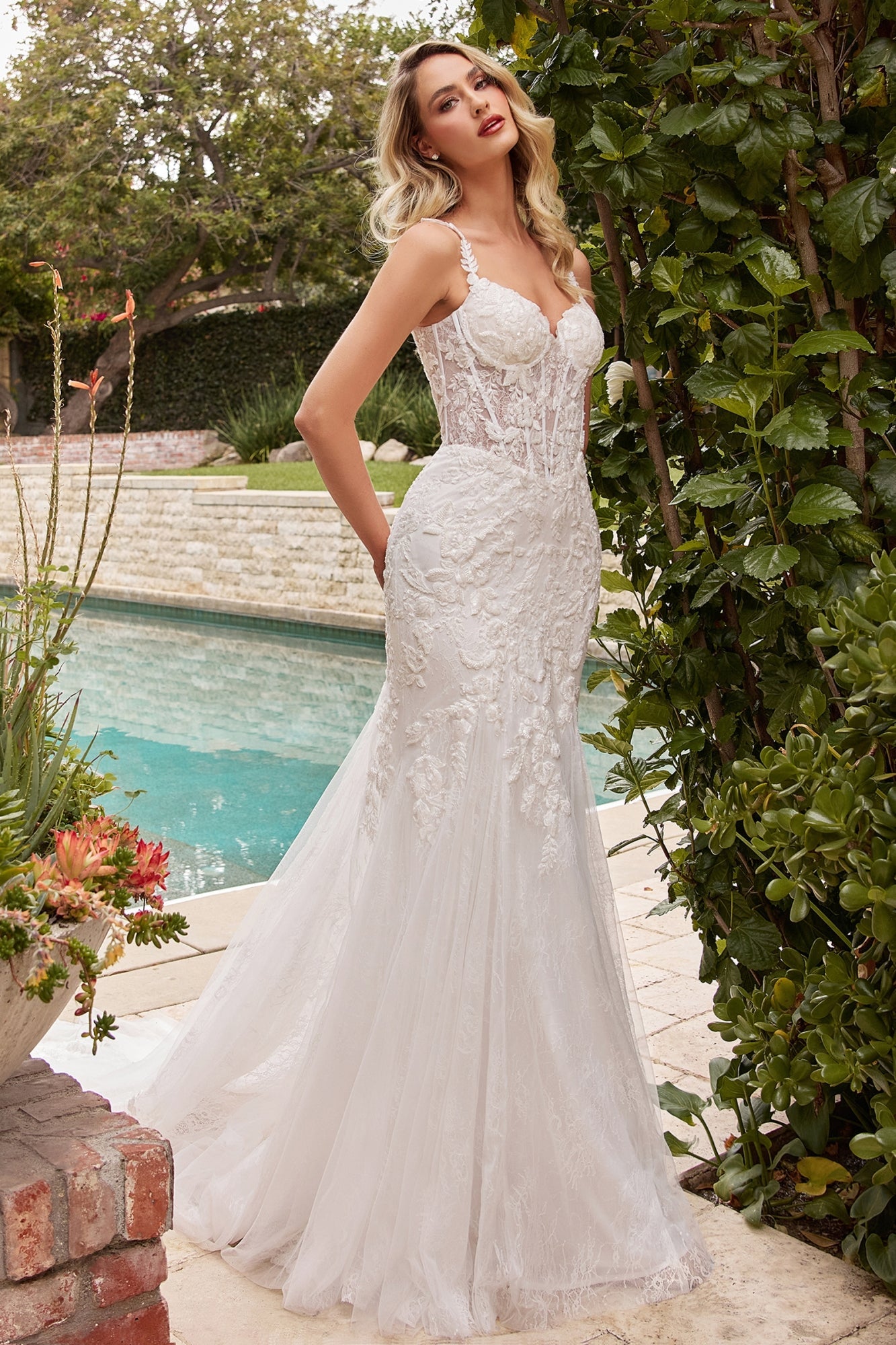 Off-white mermaid wedding gown with lace overlay, lace bodice details and sheer tulle skirt
