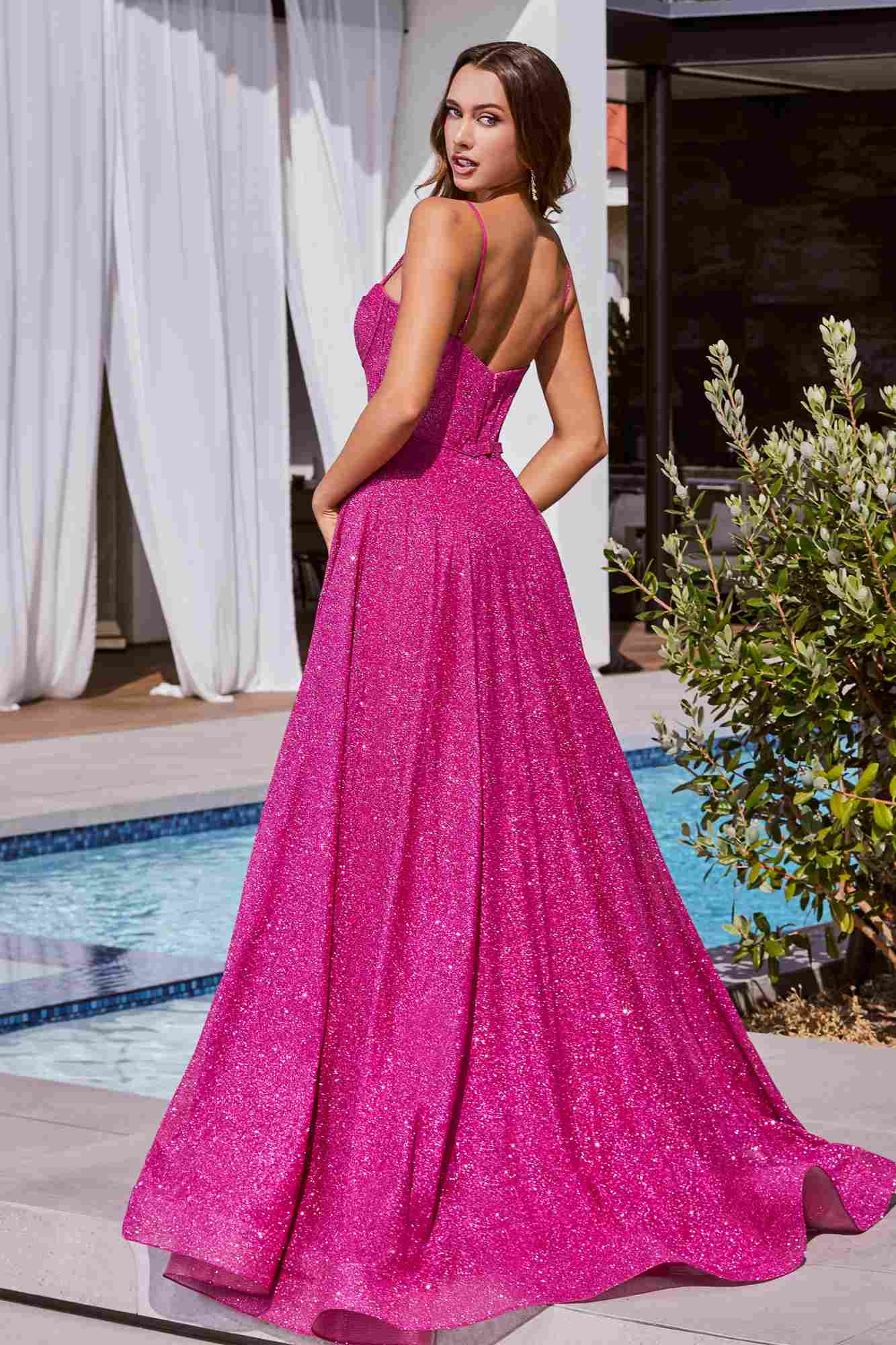Fuchsia glitter A-line ball gown with open back, thin straps, and long flared skirt