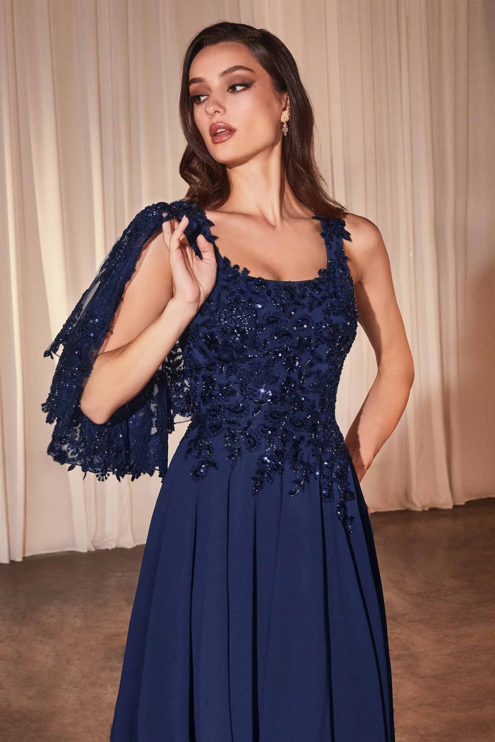 Navy blue A-line evening dress with beaded lace bodice and sheer lace cape sleeves