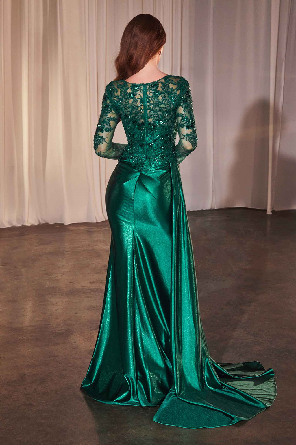 Back view of long-sleeve lace and satin fitted gown in emerald green with draped skirt
