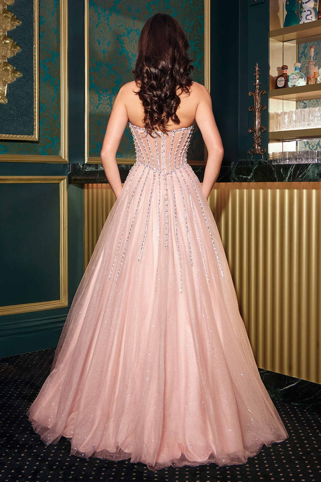 Back view of blush strapless A-line ball gown with crystal beaded bodice and tulle skirt