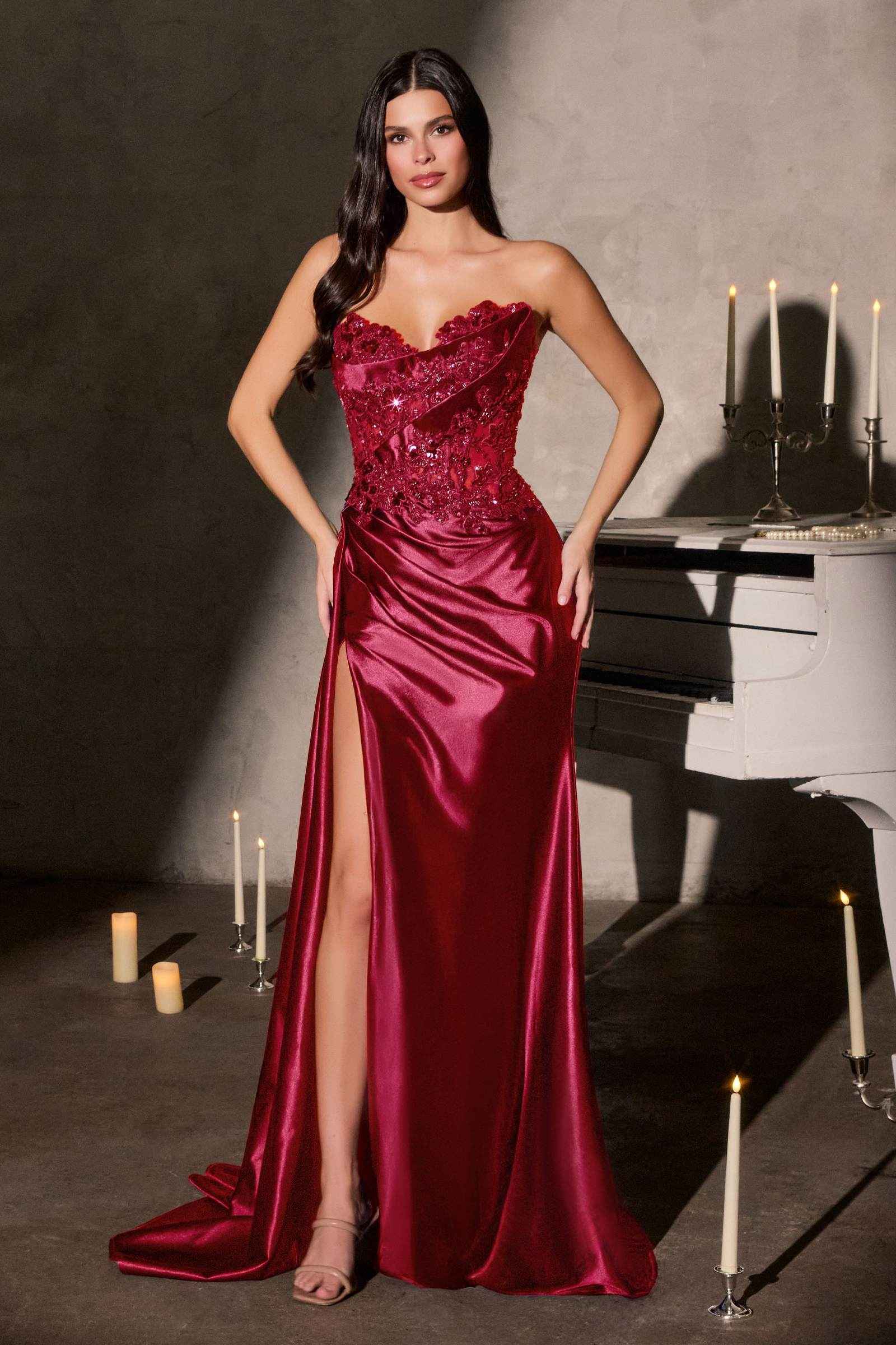 Deep red strapless satin gown with embellished bodice and thigh-high leg slit