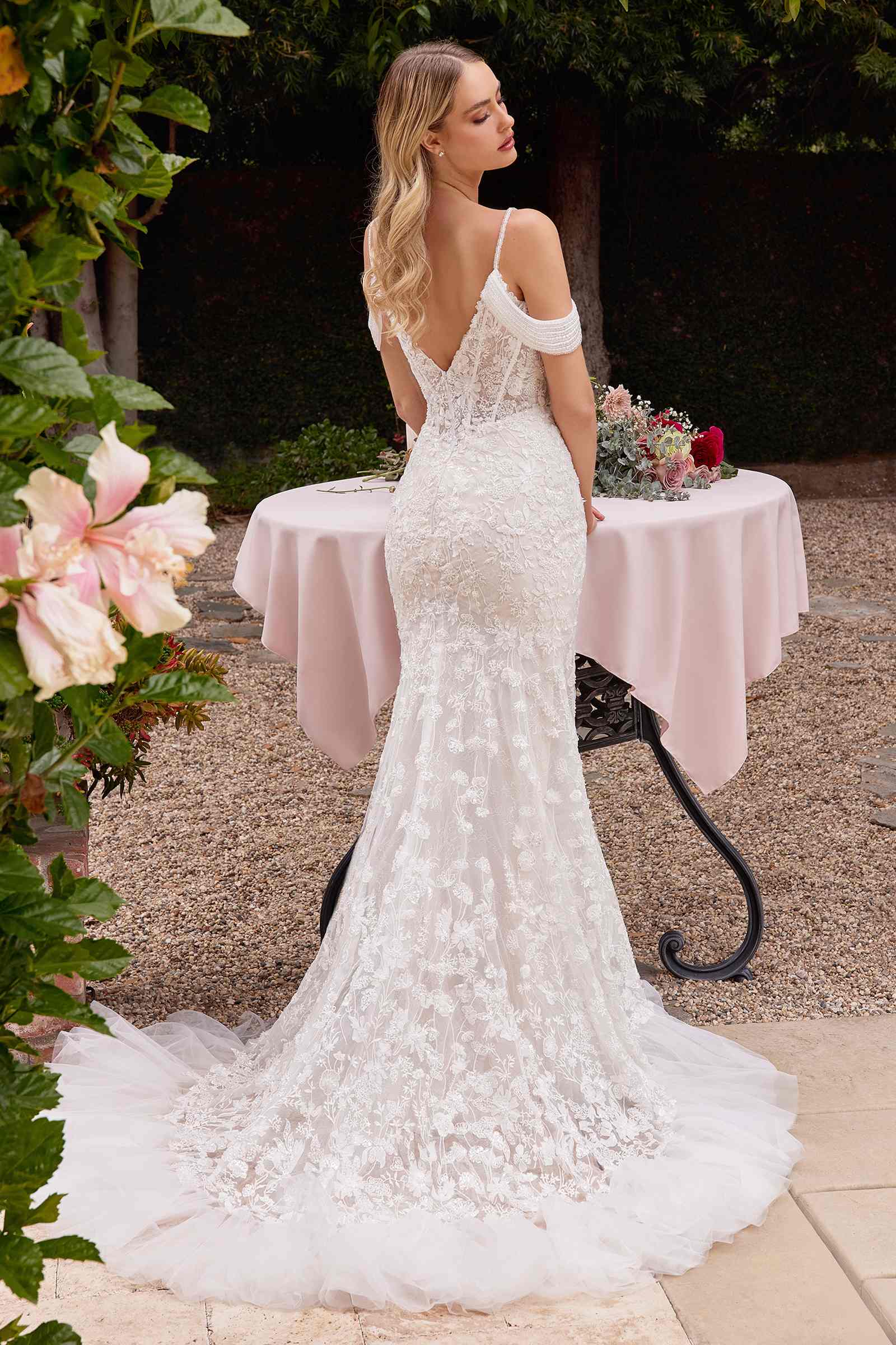 Off-white fitted lace bridal gown with open back and lace off-shoulder sleeves