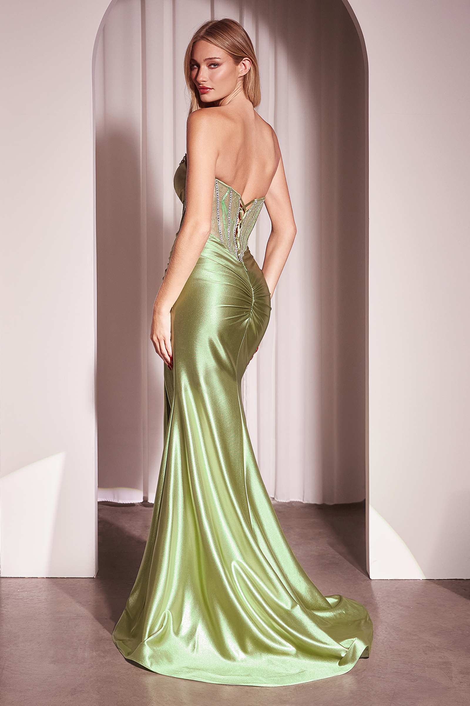 Green strapless satin fitted gown with lace corset bodice and side slit
