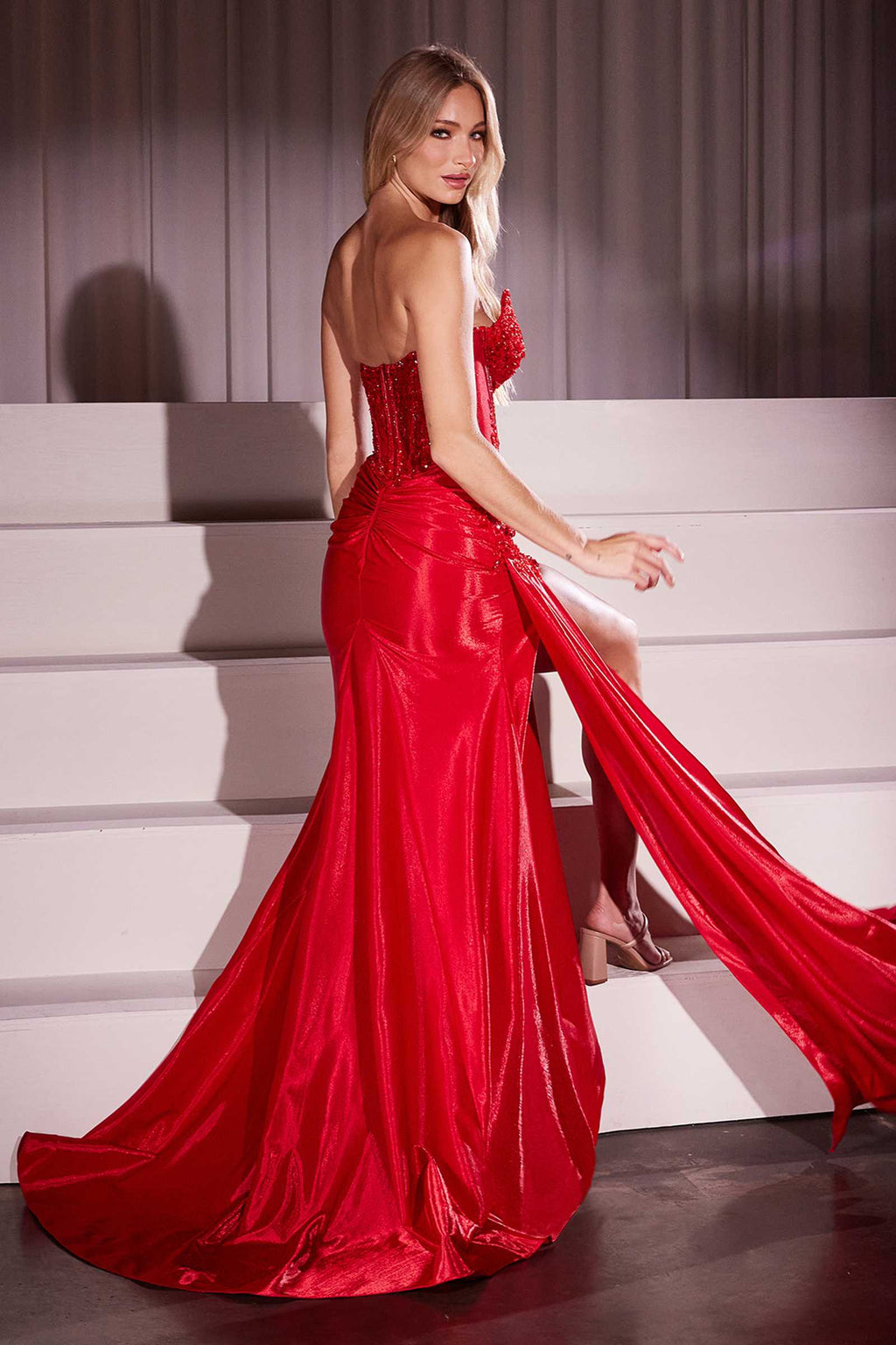 Red strapless fitted taffeta gown with embellished sweetheart neckline and side slit