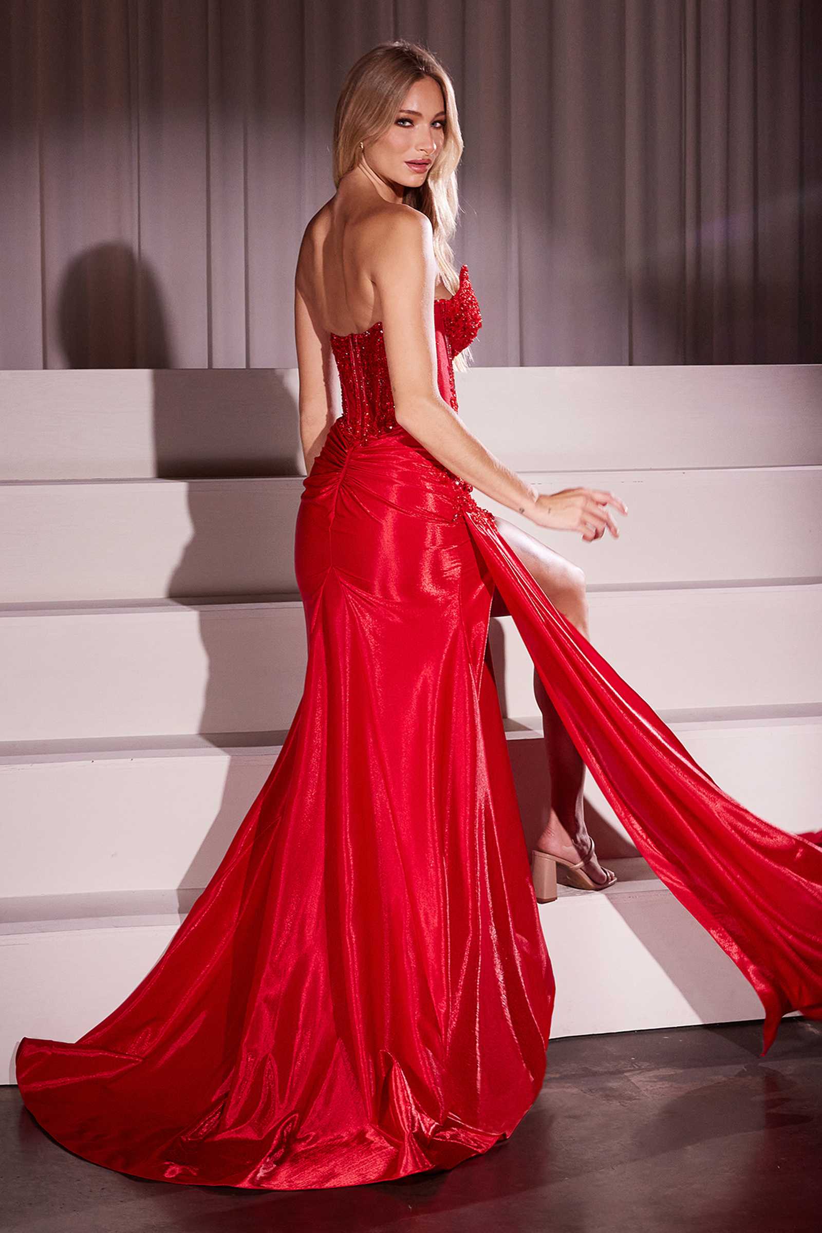 Red strapless fitted taffeta gown with embellished sweetheart neckline and side slit