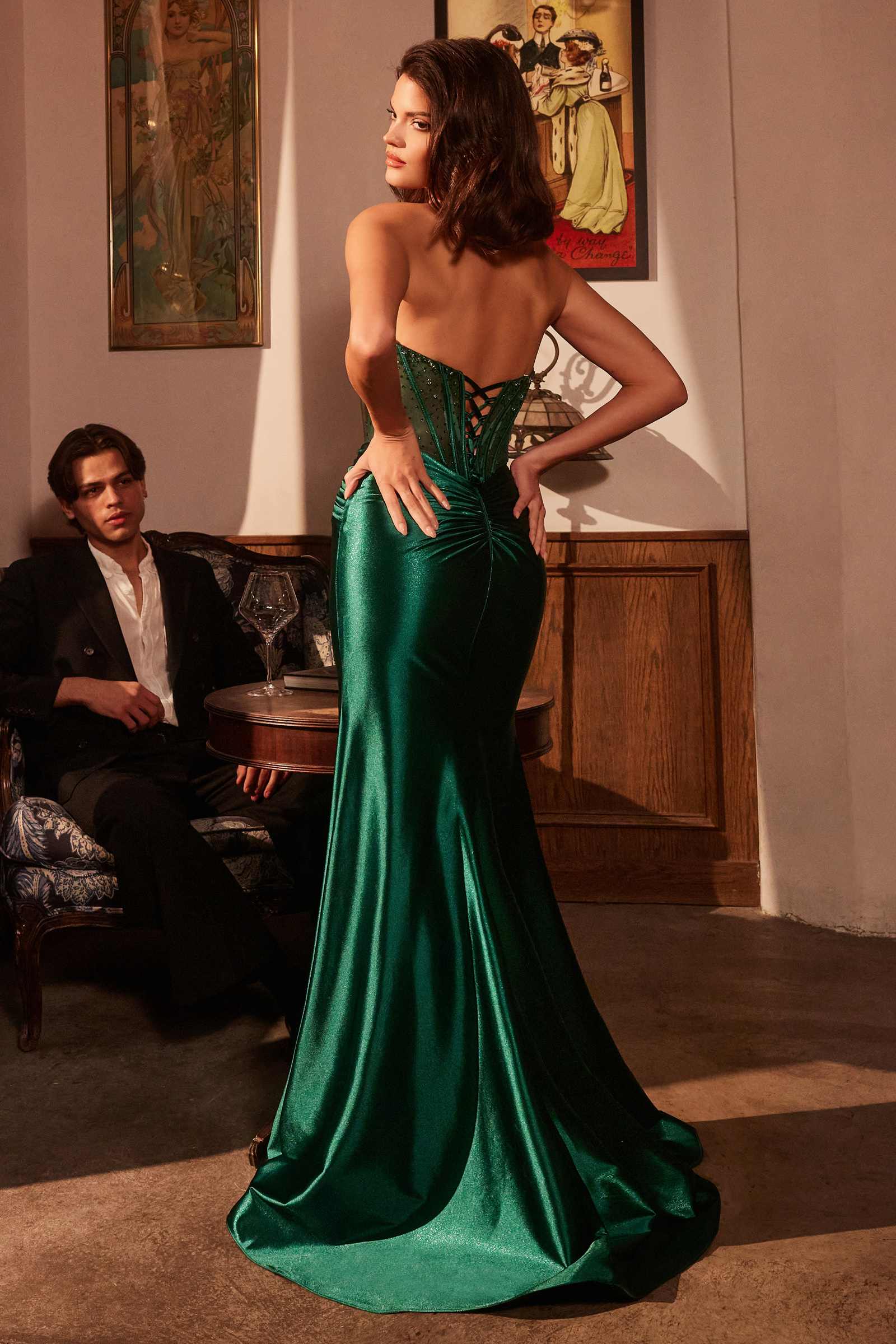 Emerald green strapless corset prom gown with lace-up open back and long side slit