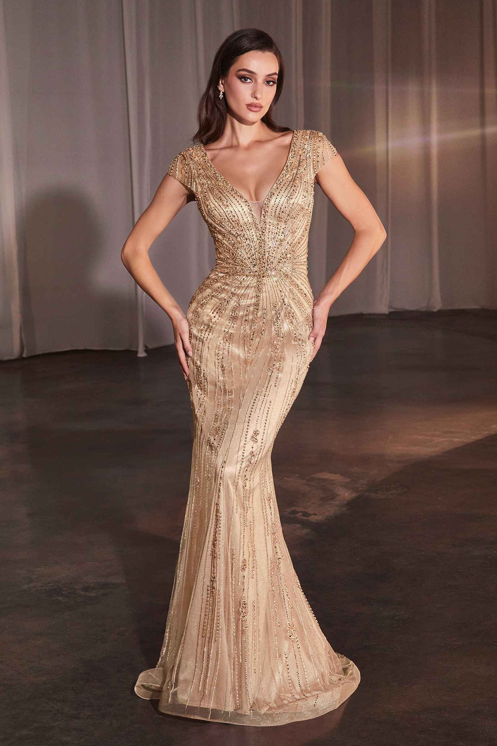 Gold long fitted beaded dress with cap sleeves, V-neck, and mermaid-style hem