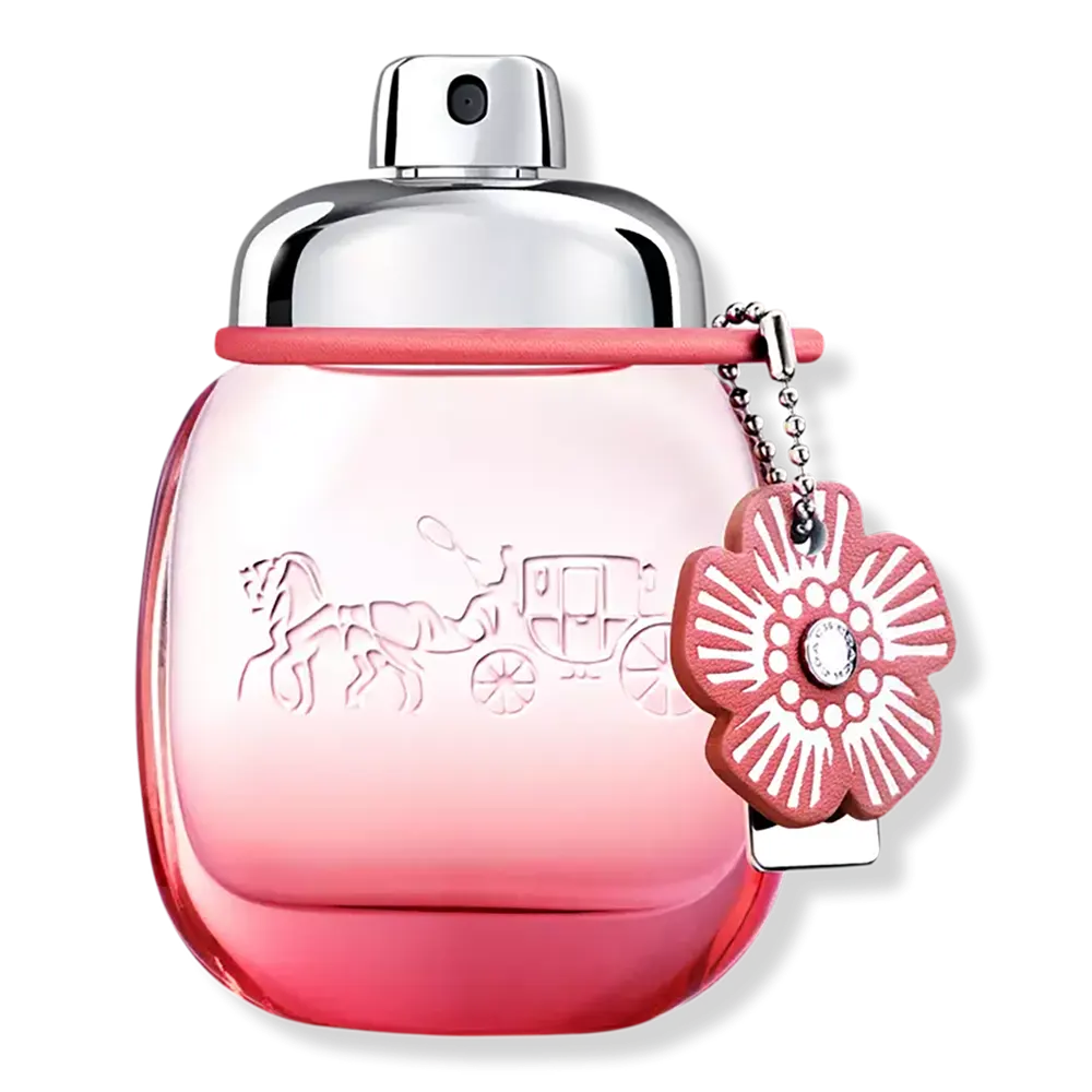 Rounded blush-pink eau de parfum bottle with red cap and floral keychain charm