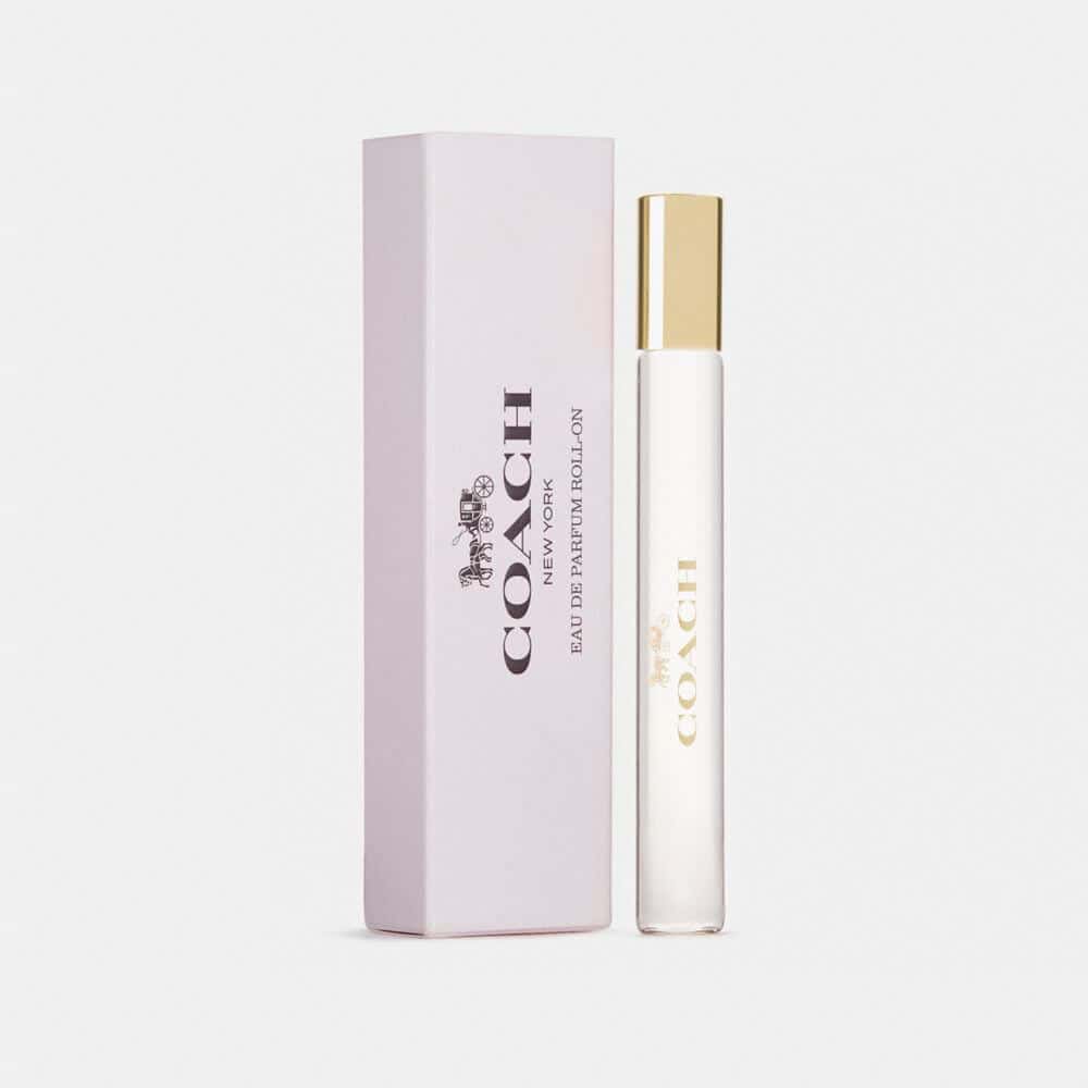 Eau de parfum rollerball with white vial, gold cap, and mauve box