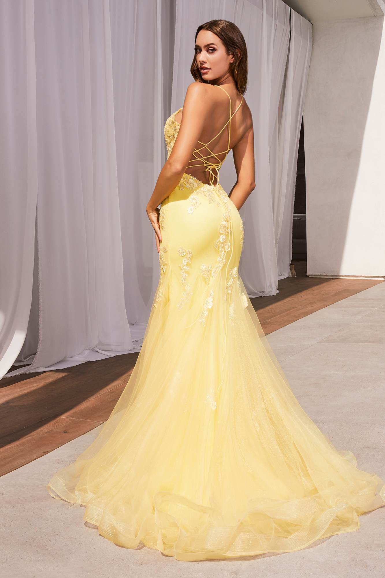 Yellow corset-back mermaid gown with floral lace bodice and tulle skirt, open back