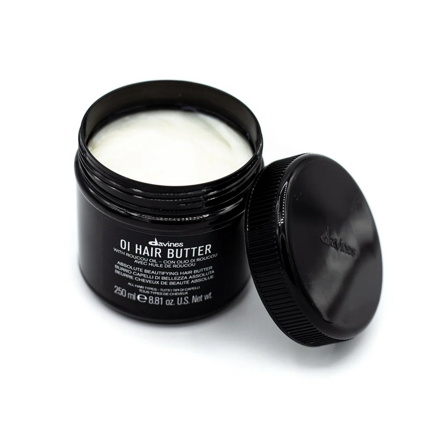 Davines OI Hair Butter jar with open black lid, white cream inside