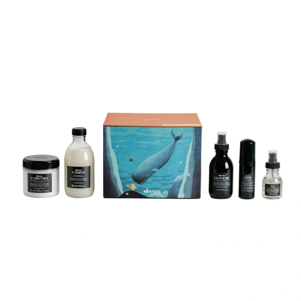 Davines OI Luxe holiday set: bottles and jars beside teal whale gift box