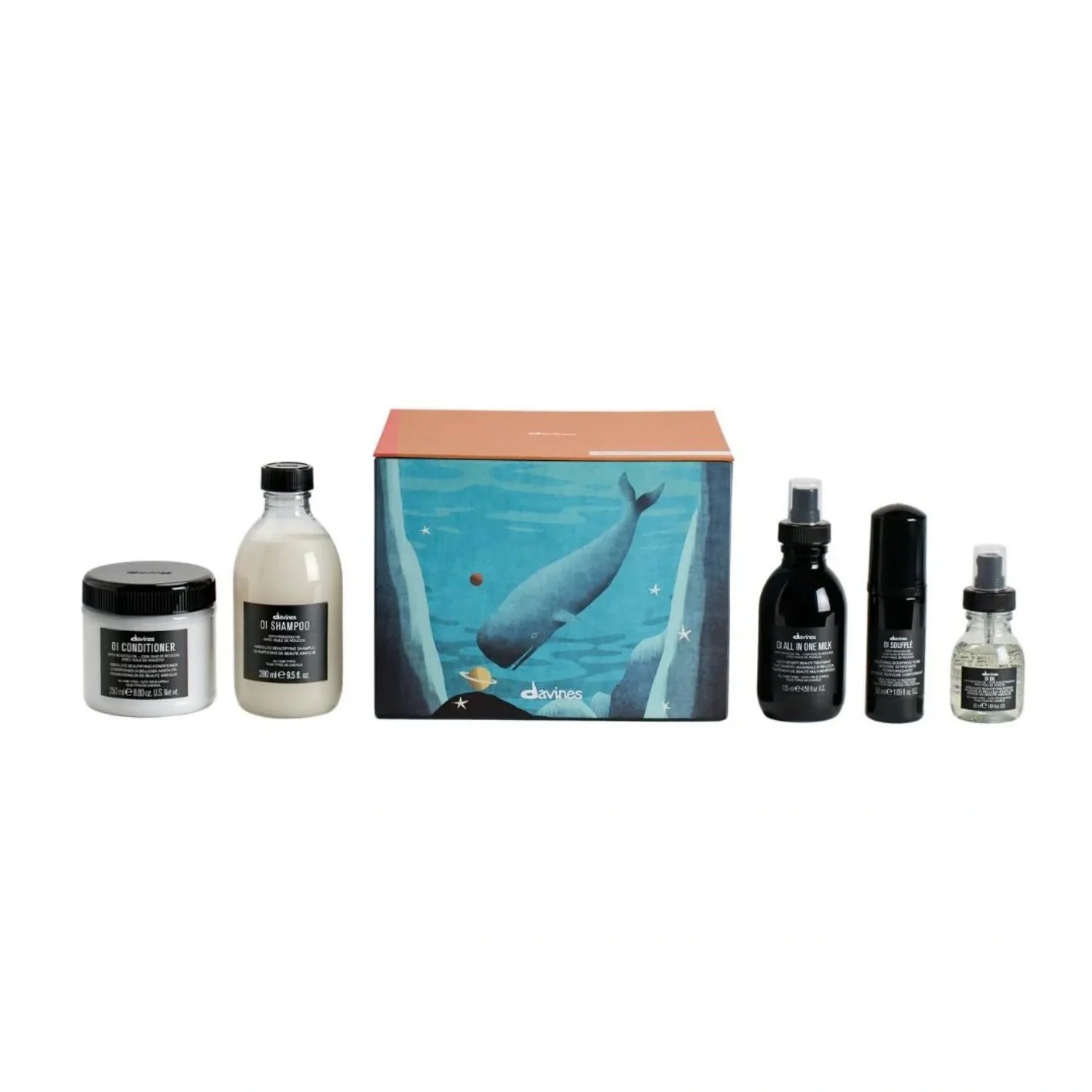 Davines OI Luxe holiday set: bottles and jars beside teal whale gift box