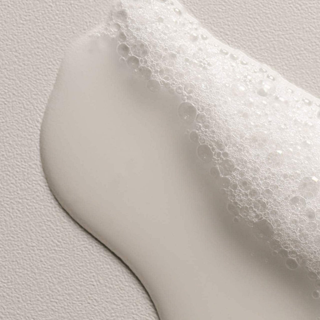 Shampoo lather with fine bubbles on a light surface