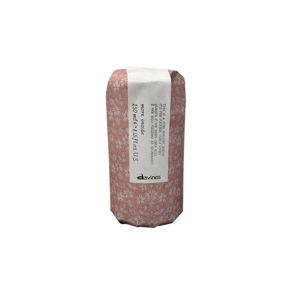 Curl building serum pouch with floral pattern and label text