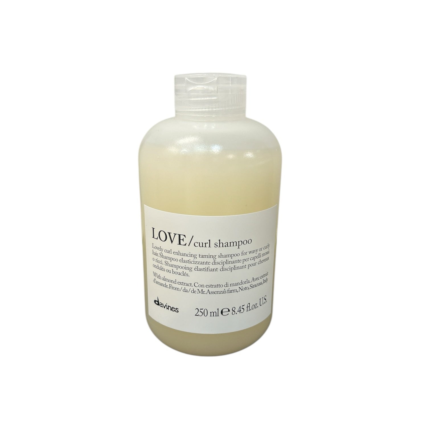 Curl shampoo bottle with white label and beige liquid