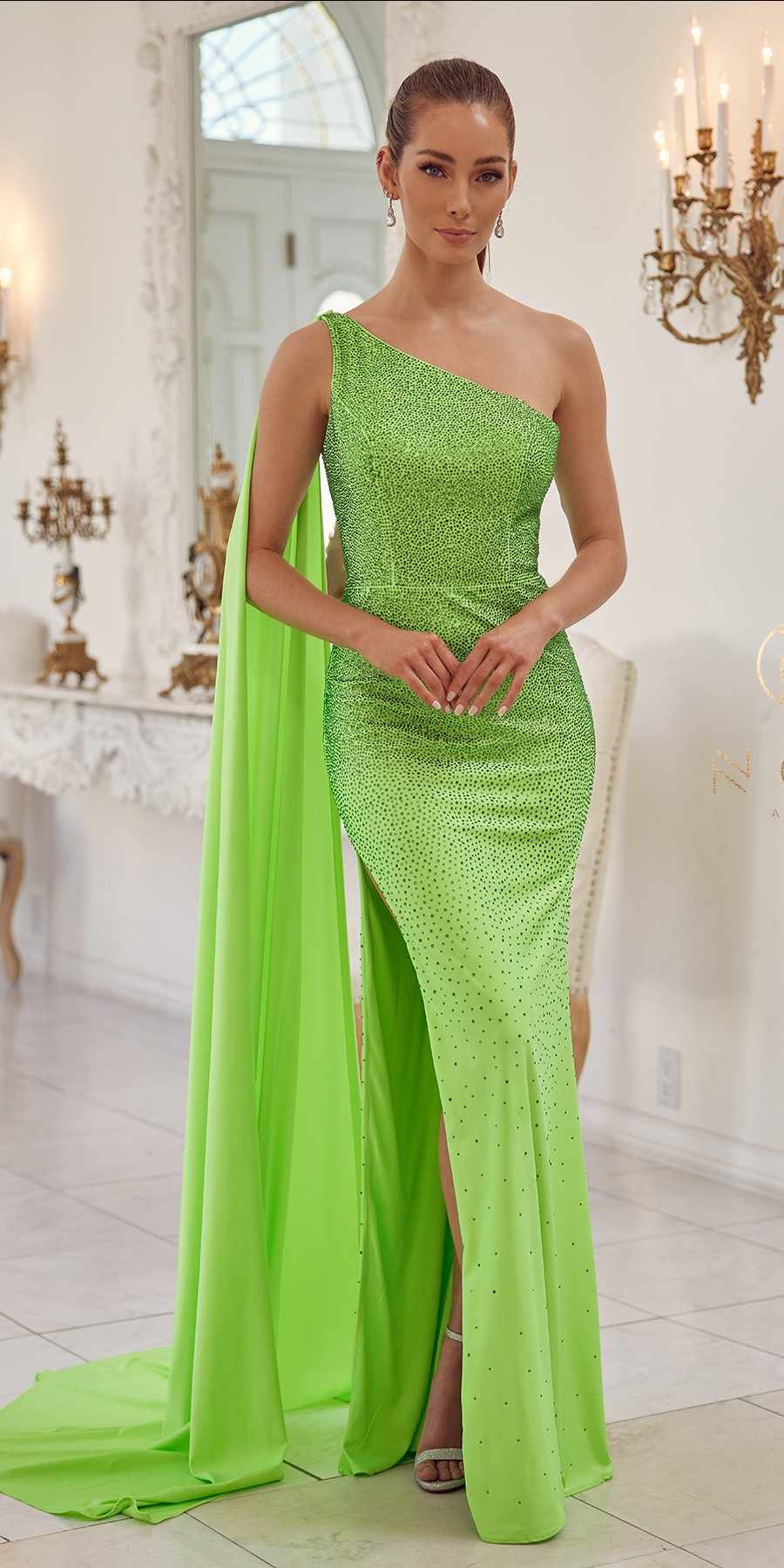 Green one-shoulder floor-length gown with beaded bodice, thigh-high slit and long train.