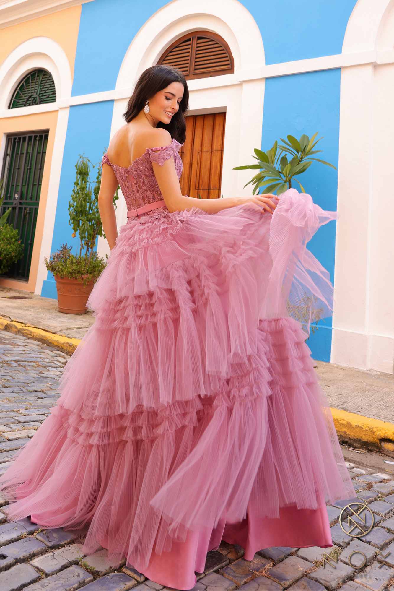 Long off-shoulder sweetheart tulle gown in pink with tiered ruffle skirt and sash