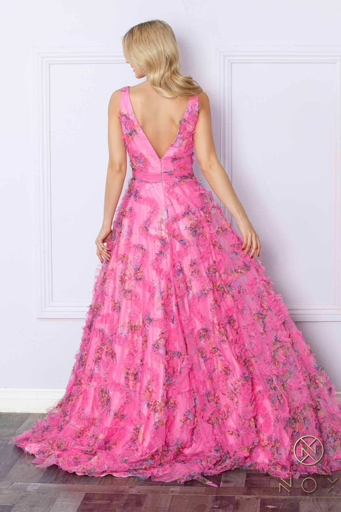 Back view of fuchsia floral print evening gown, sleeveless A-line with deep V-back and slit
