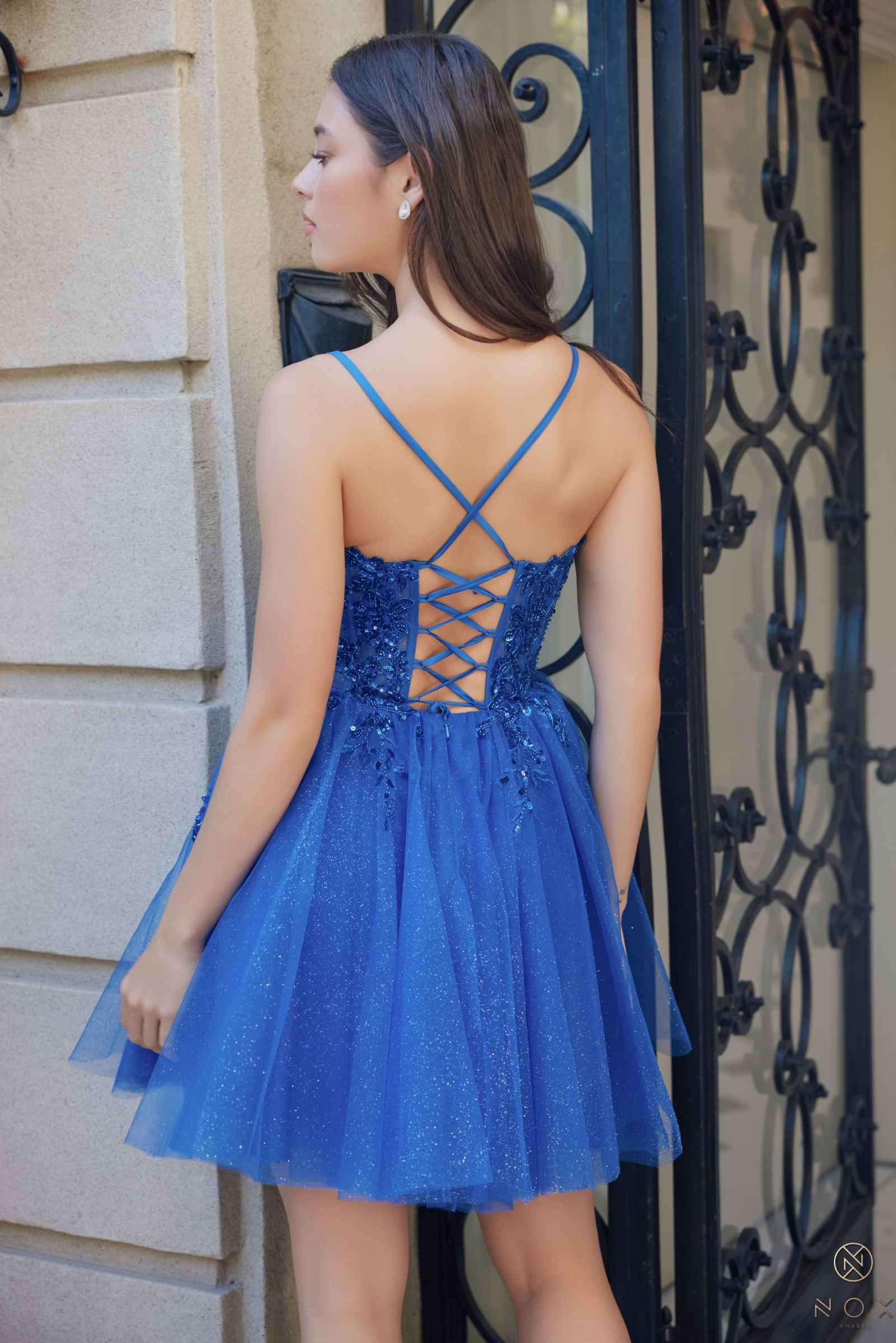 Royal blue sleeveless A-line dress with crisscross back straps and tulle skirt
