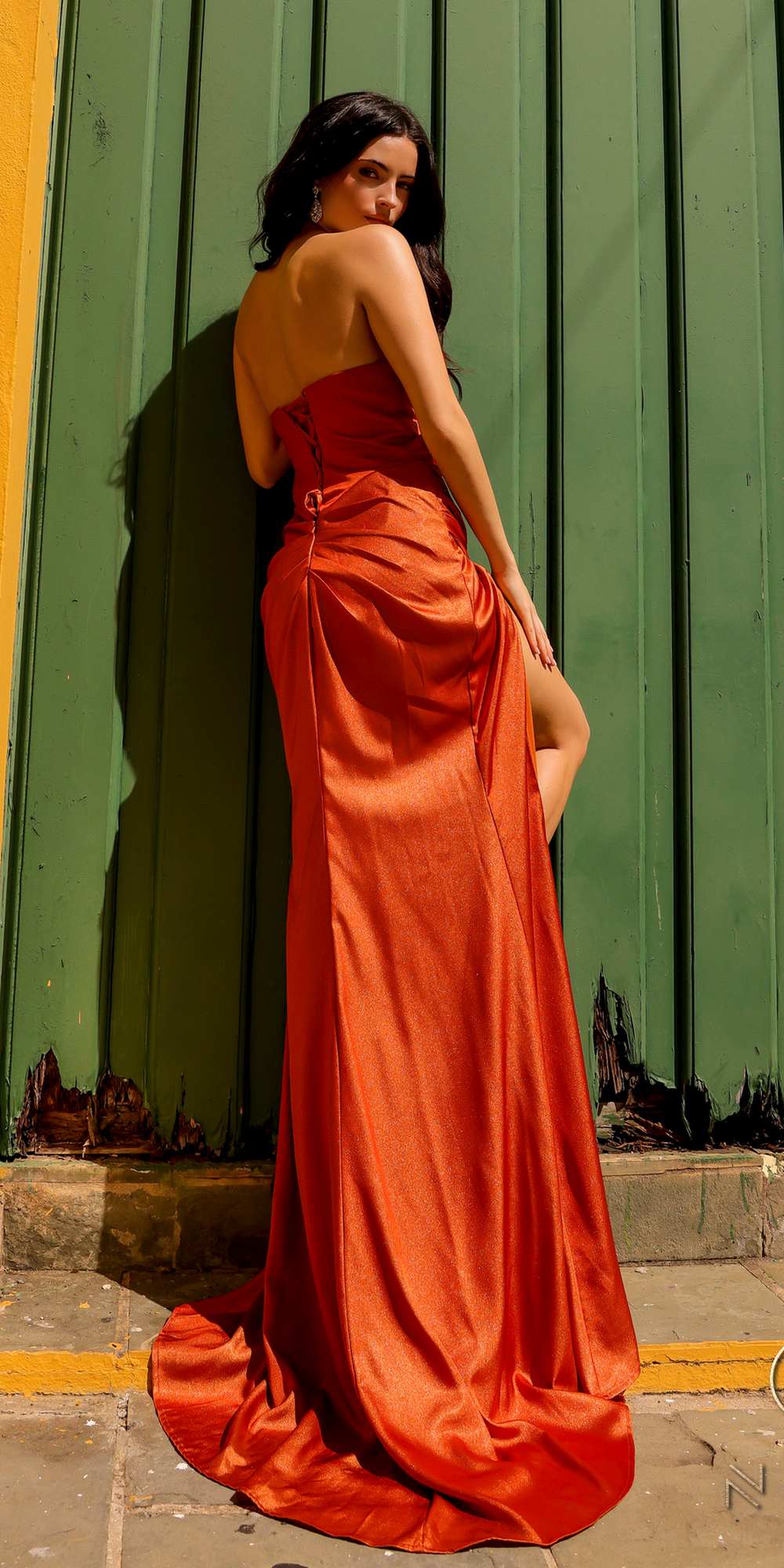 Red satin long gown with V-bodice, draped detail, and side slit.