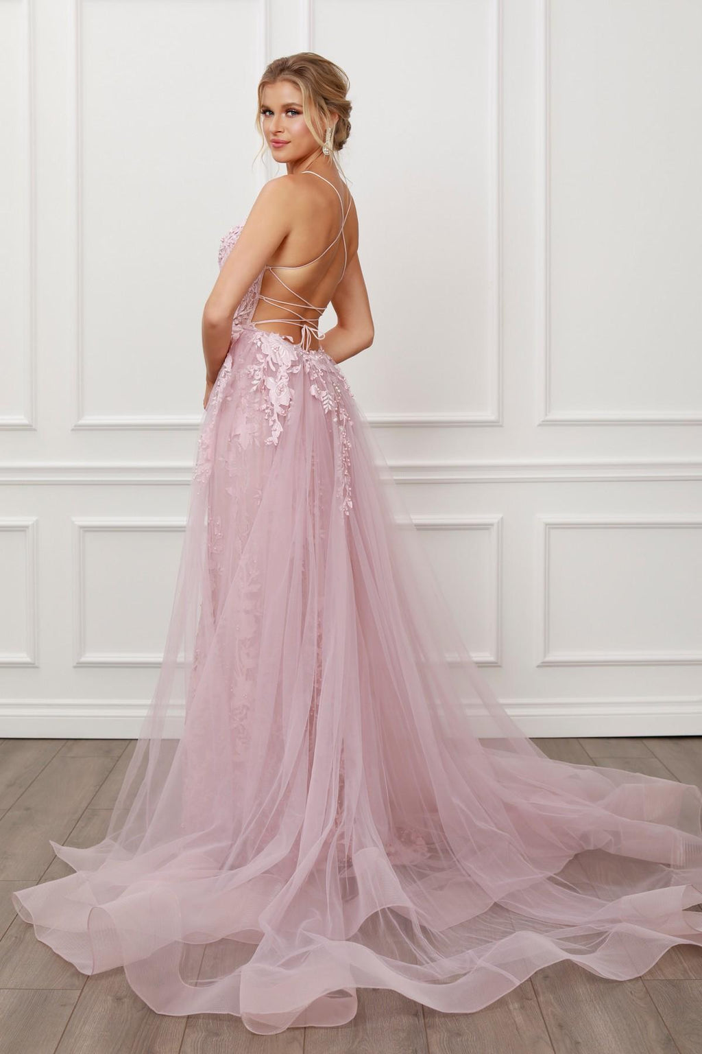 Blush mermaid lace gown with beaded bodice and sheer tulle overskirt, angled back view