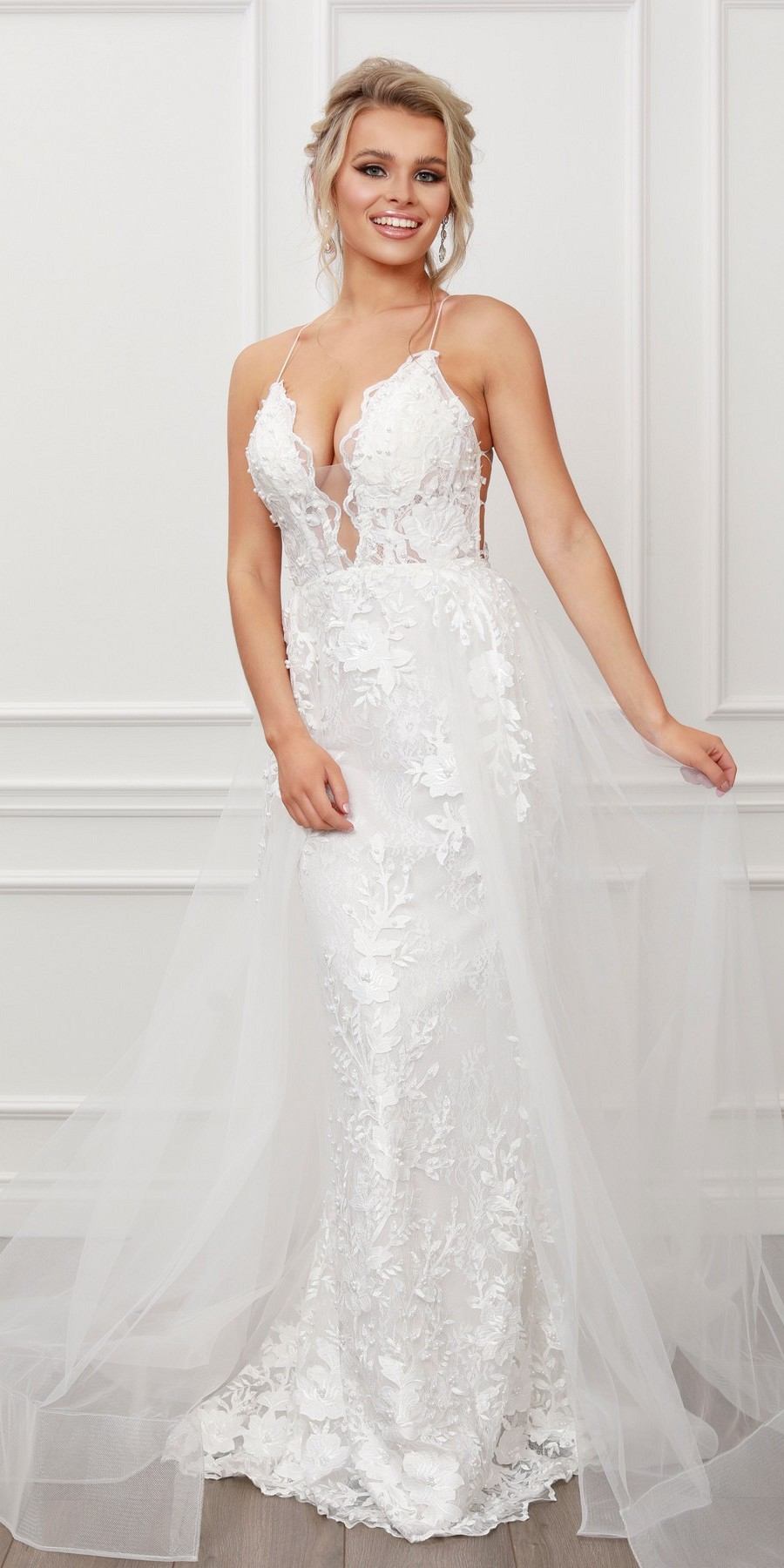 Light mermaid gown with lace applique, beaded V-neck bodice, and layered tulle overskirt