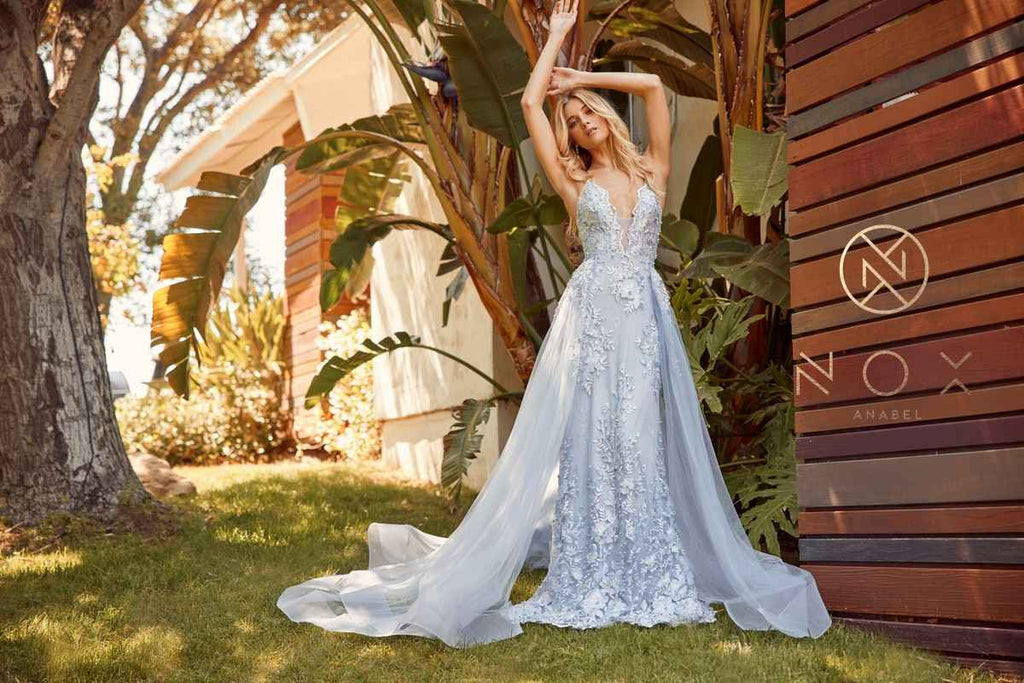 Light blue lace mermaid gown with chiffon overskirt and crisscross back straps, back view