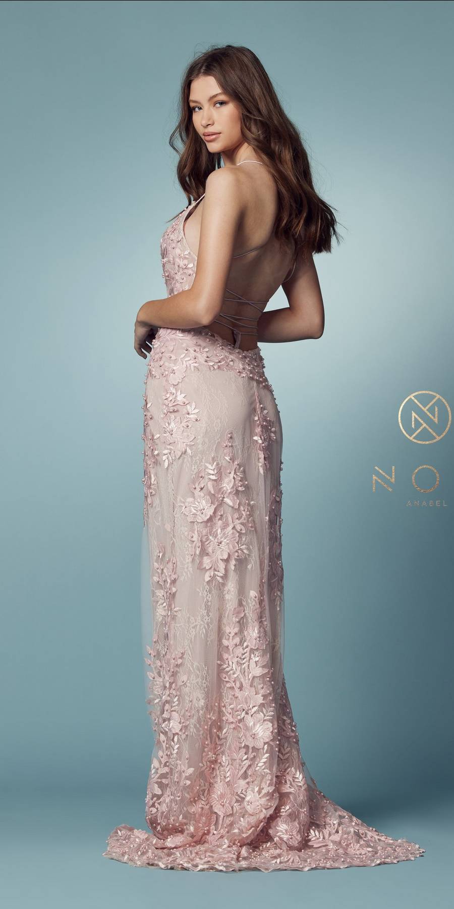 Blush mermaid gown with lace applique, spaghetti straps, and sheer flowing train