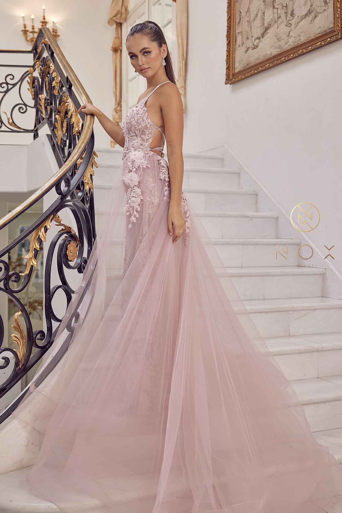 Blush mermaid lace gown with beaded bodice and sheer tulle overskirt, side back view