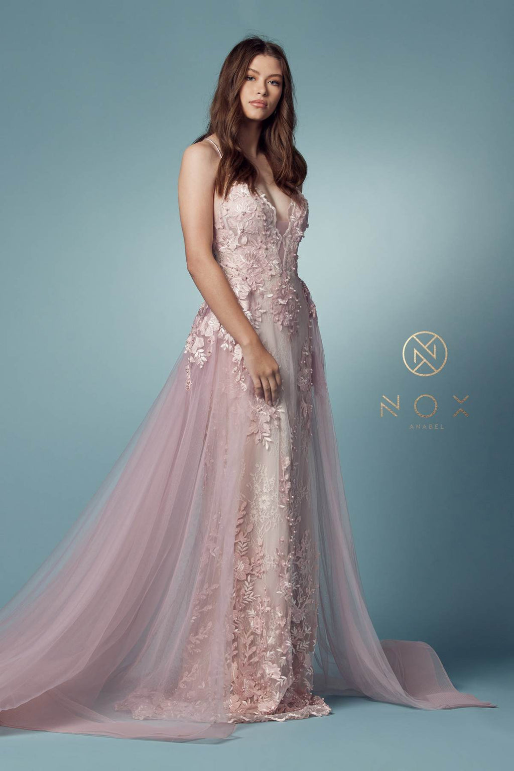 Blush mermaid lace gown with beaded bodice and sheer tulle overskirt, standing full view