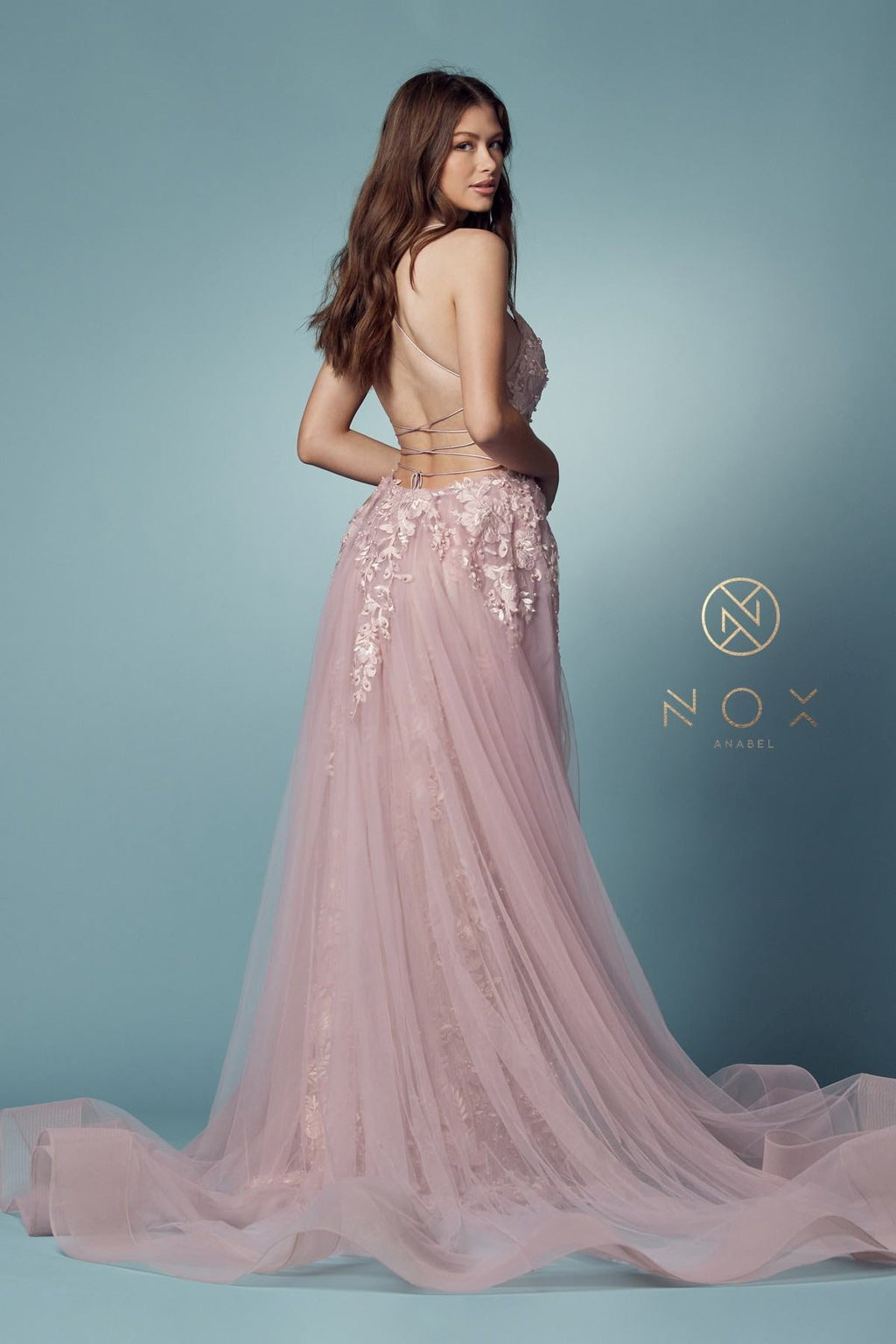 Blush mermaid lace gown with beaded bodice and sheer tulle overskirt, back side view